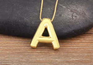 Gold plated bubble letter A necklace detail closeup view, trendy minimalist jewelry piece.