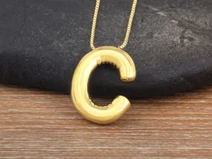 Gold tone letter C bubble pendant necklace close up detail stylish fashion accessory