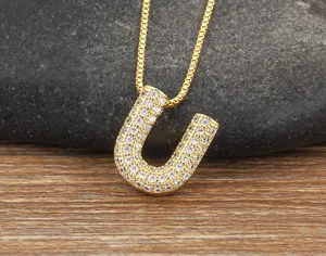 Stunning gold-plated micro-paved cubic zirconia letter U pendant necklace detail view.