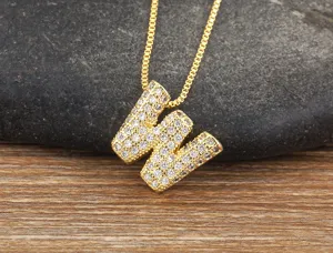 Gold letter W pendant necklace micro pave cubic zirconia close-up detail shot for elegant wear.