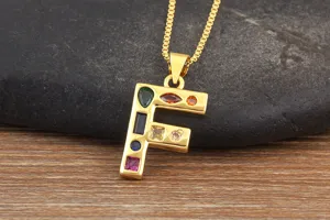 Gold plated letter F pendant necklace adorned with sparkling multi-color cubic zirconia.