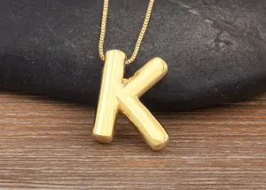 Detail shot of a trendy 18k gold plated puffy letter K pendant necklace, chic and minimalist daily.