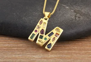 Gold plated letter M pendant necklace sparkling with colorful cubic zirconia stones.