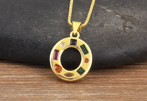 Detailed shot of a gold-plated letter O pendant necklace inlaid with vibrant multicolored cubic zirconia.