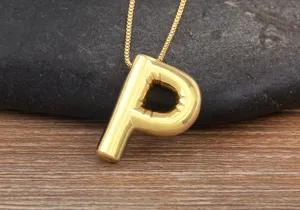 Gold bubble letter P pendant necklace close up view showing shiny metallic smooth surface texture