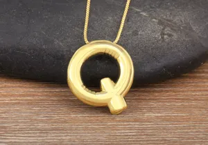 Gold letter Q pendant necklace close-up, 18k gold plated dainty initial necklace for women daily.