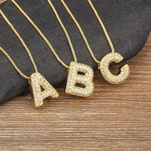 Gold letter pendant necklaces set featuring sparkling micro-pave cubic zirconia alphabet charms.