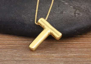 18k gold plated bubble letter T pendant necklace, smooth minimalist design detail shot.