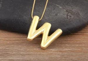 Gold plated puff letter W pendant necklace, smooth surface style, minimalist fashion jewelry.