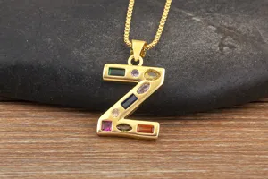 Detailed closeup view of gold plated letter Z pendant necklace decorated with multi color stones.