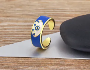 Chic evil eye open ring for women, 18k gold plated copper with vibrant blue enamel design.
