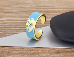 Close-up detail of the 18k gold plated evil eye open ring featuring blue enamel design.