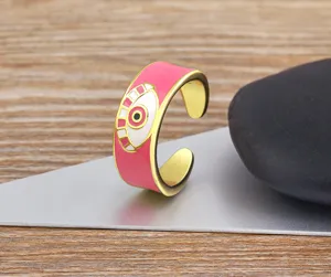 Close-up detail of the pink enamel evil eye open adjustable ring, gold plated jewelry.