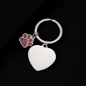 Stainless steel key chain with glitter paw charm and heart pendant for personalized gifts.