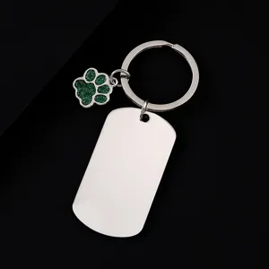 Stainless steel military tag keychain with green glitter dog paw pendant, perfect for laser engraving.