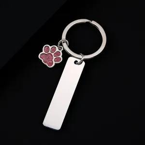 Stainless steel keychain with glitter puppy paw charm and blank tag for custom laser engraving.