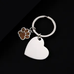 Stainless steel metal keychain with glitter paw charm and blank heart pendant detail.