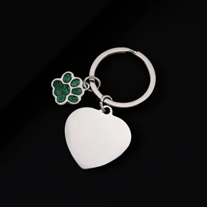 Stainless steel metal keychain with green glitter dog paw and blank heart pendant detail.