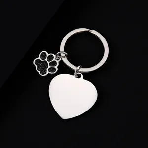 Stainless steel metal keychain detail showing glitter dog paw and blank heart charm for engraving.