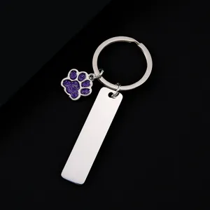 Stainless steel keychain with purple glitter paw print pendant and blank metal engraving tag.