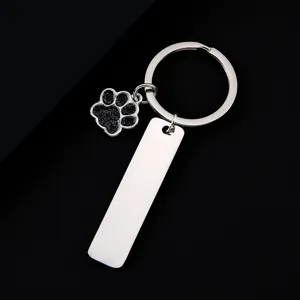 Stainless steel keychain with black glitter dog paw charm and blank tag for laser engraving.