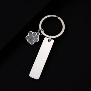 Stainless steel keychain featuring a glitter paw print charm and blank tag for laser custom engraving.