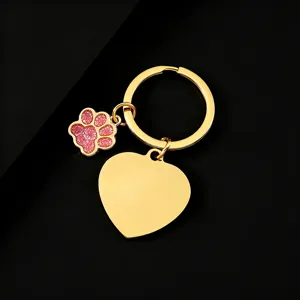 Gold stainless steel metal keychain featuring a blank heart pendant and a cute pink glitter paw charm.