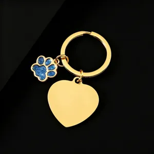 Stainless steel gold metal keychain with heart blank pendant and blue glitter dog paw charm.