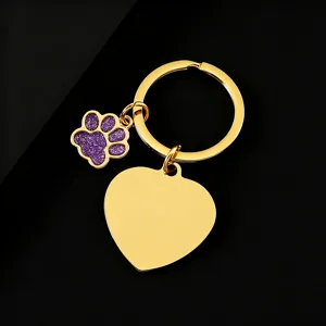 Stainless steel gold keychain with purple glitter paw print and blank heart charm.