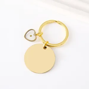 Stainless steel mustard seed keychain detail showing the clear heart charm and gold blank disc.