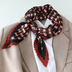 Close-up detail shot showcasing the elegant pleated satin scarf with a chic geometric grid pattern.
