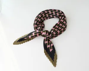 Pleated satin square scarf detail, pink and green checkered pattern, soft fabric accessory.