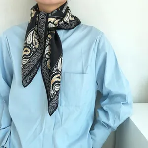 Black silk scarf detail, baroque paisley pattern, elegant neckerchief worn by model.