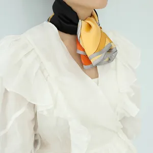 Detailed view of women silk square scarf featuring a stylish color block design and elegant drape.