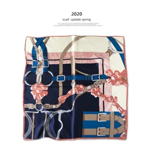 Detailed view of luxury silk scarf featuring classic belt and floral equestrian print design.