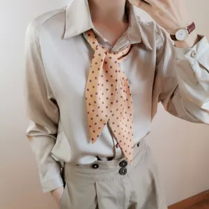 Vue détaillée d'un foulard étroit à pois pour femmes, élégante écharpe en soie.