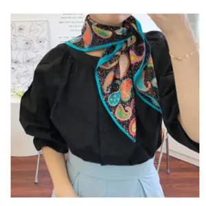 Elegant silk scarf with vibrant paisley pattern and blue border for women autumn fashion.