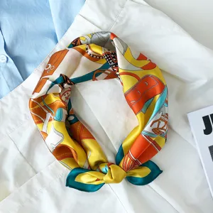 Detail close-up of luxury silk scarf with elegant handbag print, chic fashion accessory.