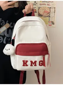 Vista detallada de la mochila blanca infantil con bolsillo rojo, parche KMG y tierno peluche.