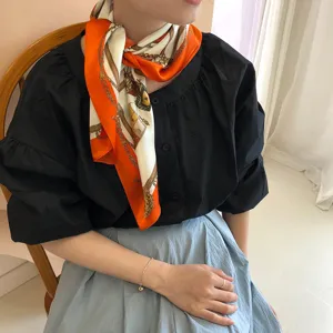 Elegant silk square scarf featuring luxury chain and carriage print for women fashion styling.