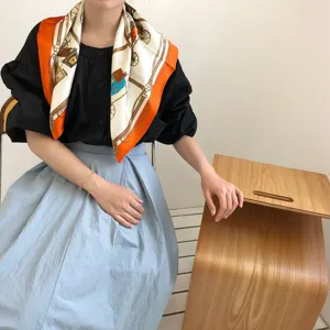 Elegant women's silk scarf featuring luxury carriage and chain print design for autumn and winter.