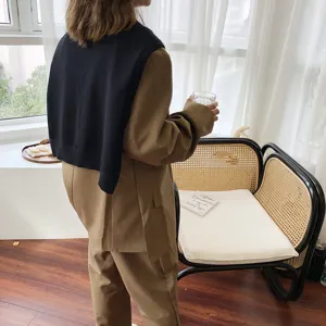 Detailaufnahme eines eleganten einfarbigen Damen Strickschals kombiniert in hellem Innenraum.