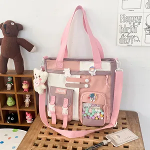 Joli sac cabas en toile avec plusieurs poches, bandoulière, design color block doux pour l'école.