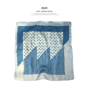 Silk square scarf with blue and white geometric crescent moon print, fashionable accessory.