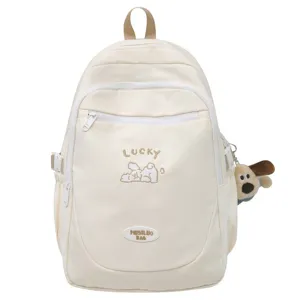 Detailed view of the cute beige canvas backpack featuring lovely dog embroidery and front pocket.