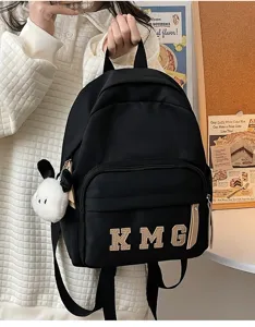 Mochila negra para ninos bolsa escolar de viaje linda con parches de letras vista de detalle