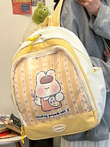 Zaino ita giallo e bianco carino con tasca anteriore in PVC trasparente per spille e peluche.