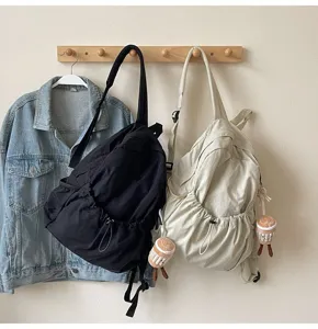 Detail view of casual nylon backpack with cute pendant, lightweight and large capacity travel bag.