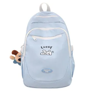Light blue canvas student backpack detail with cute dog pendant and lucky embroidery.