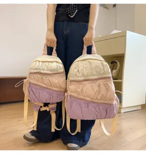Vista dettagliata dello zaino leggero plissettato con strati multicolore e spallacci.